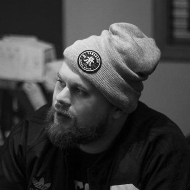 A black and white portrait of Trox wearing a beanie.